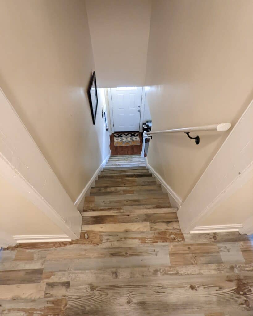 Farm style wood floors installed on a staircase